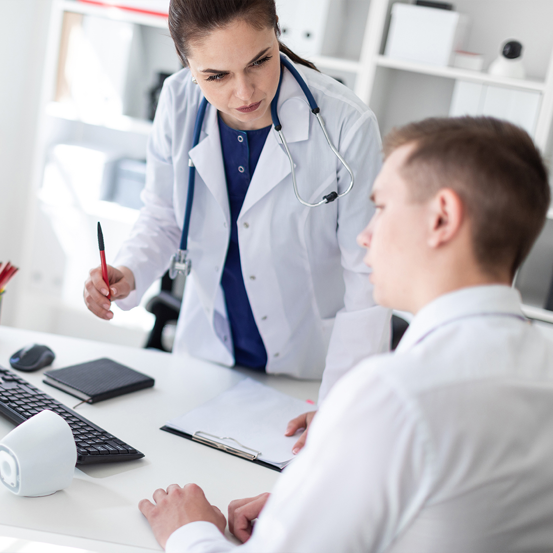 A doctor and patient in an office setting.