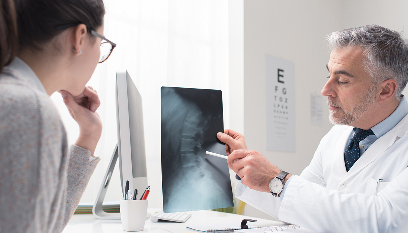 A doctor and patient looking at an x-ray.